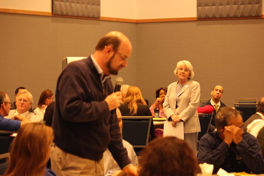 Hahs listens intently as speakers present.