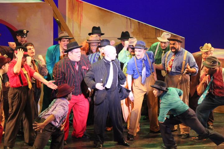 The cast of Guys and Dolls gambles on stage.