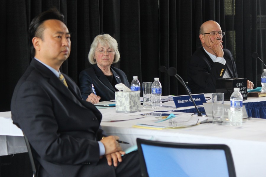 Trustees Jin Lee, Sharon K. Hahs, and Carlos Azcoitia (from left to right) amid the public comment portion of their meeting, receiving both supportive and negative feedback.