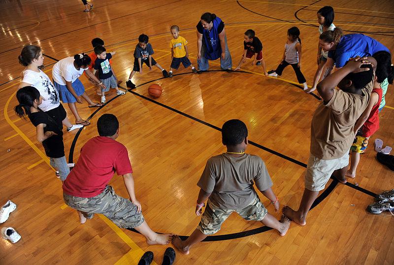 Teachers lead community children in a bonding game.