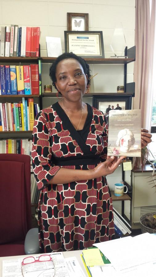 Dr. Jeanine Ntihirageza, pictured with Forgotten Genocides, a series of essays and analyses edited and compiled by French-American political scientist, Dr. René Lemarchand.
