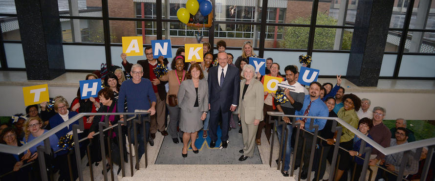 Daniel L. Goodwin stands alongside faculty, staff and students at the landing of the Presidents Office.