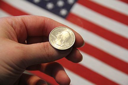 The Iowa caucuses were so close a coin toss was used to determine the winner of the Democratic delegates./Photo illustration by Mary Kroeck