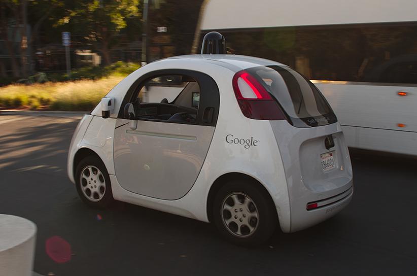 A+Google+self+driving+car+drives+past+a+double-deck+commuter+bus+at+Googles+headquarters+in+Mountain+View%2C+California.%2FPhoto+by+Michael+Shick+via+Wikimedia+Commons