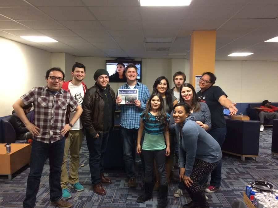 Student Media Advisor, Travis Truitt, taking a photo with some of the Independent newspaper staff.