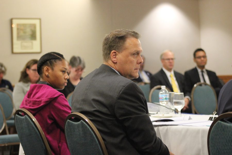 Student Trustee Olivia Clark (right) and Trustee George Vukotich (left) listen as discussions progress about NEIU’s future. 
