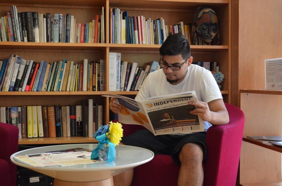 NEIU student Alfredo Palafox reads the Independent next to the Angelina Pedroso for Diversity and Intercultural Affairs Research Center