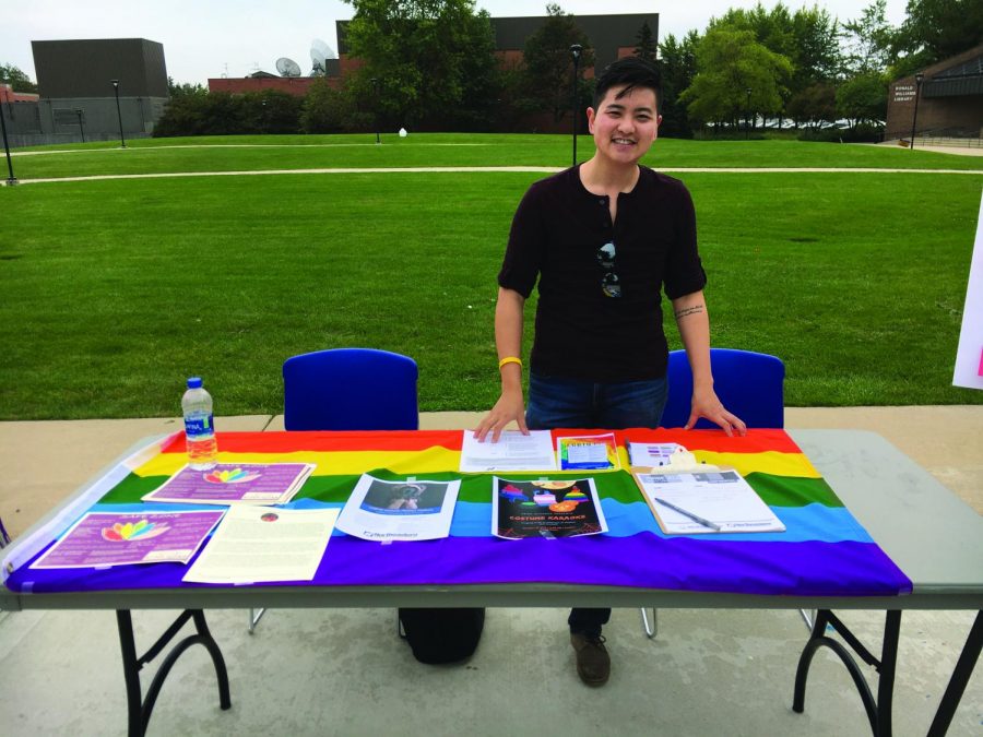 Francis Ahn welcomes students to the resource fair at the Pride Alliance table. | Photo by Rebecca Denham