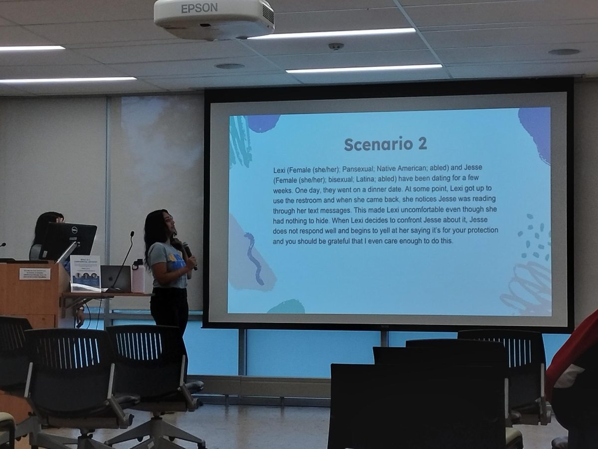 Student presenting a slide with a scenario written on it. Photos By Author