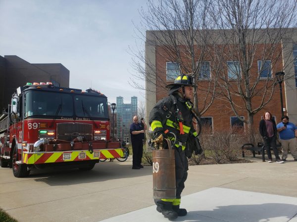 Chicago Fire Department pulled up their engine to the Student Union entrance. A firefighter (center) carries extinguisher to the cafeteria