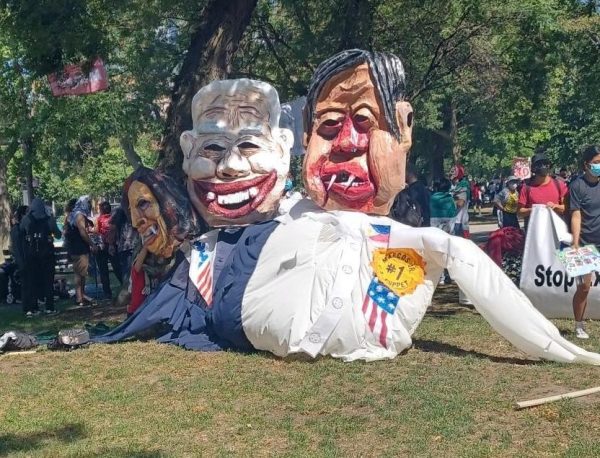 Outdoors puppet heads of US Vice President Kamala Harris, US President Biden and Philippines President Marcos Jr with vampire teeth and red lips are displayed at the park.