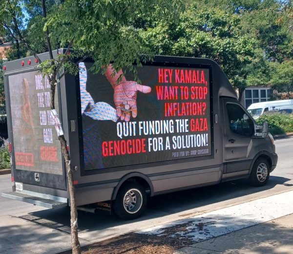 A black van parked on the street near Union Park displays in red and white letters "Hey Kamala, Want to Stop Inflation? Quit Funding the Gaza Genocide for a Solution!"