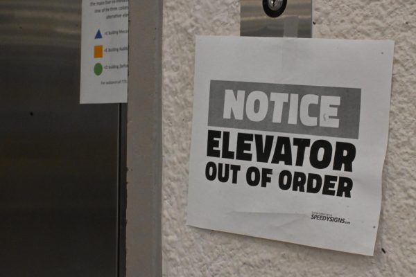 Cafeteria Elevator in Student union with a out of order sign on elevator button.