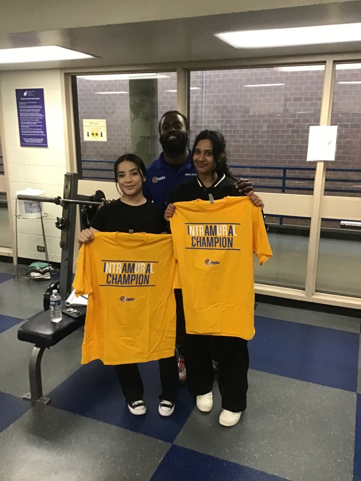 Bench press participants Yaseen (Right) and Orozco (Left) posing with facilitator Wayne Hayer (back)